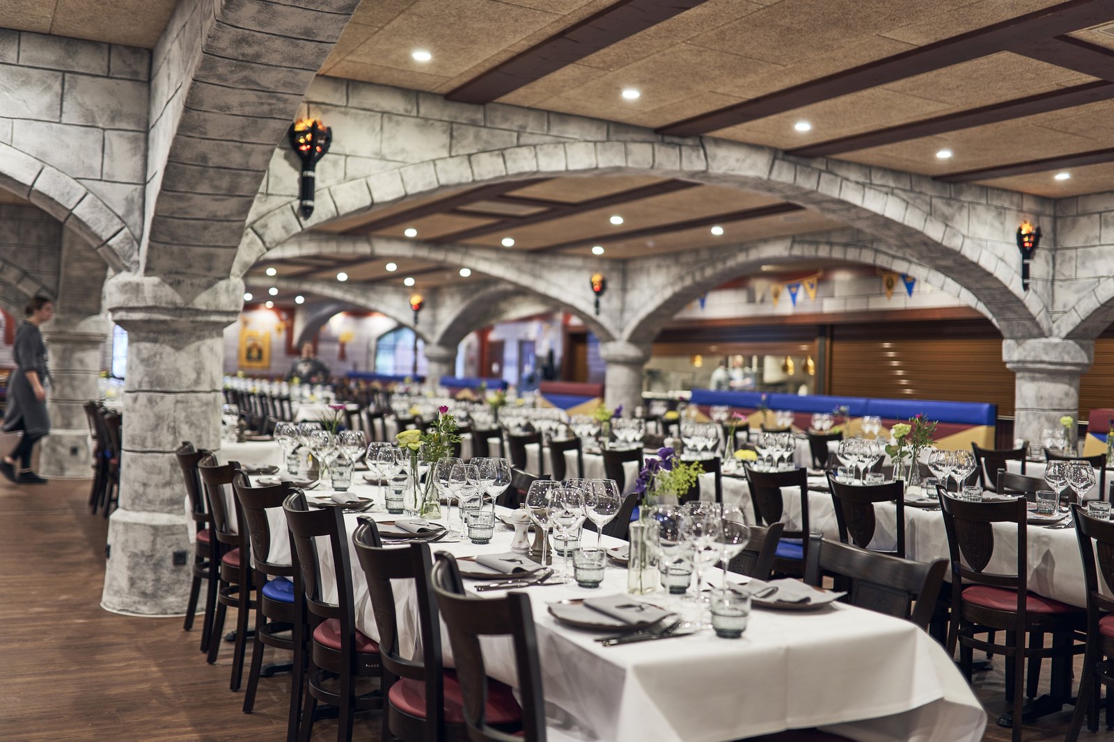 Knights’ Tavern på Castle Hotel – en restaurantsal med hvelvede steinbuer, fakkellamper og dekkede langbord.